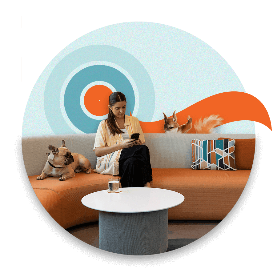 women sitting on couch with dog to her left and squirrel popping up behind couch on right